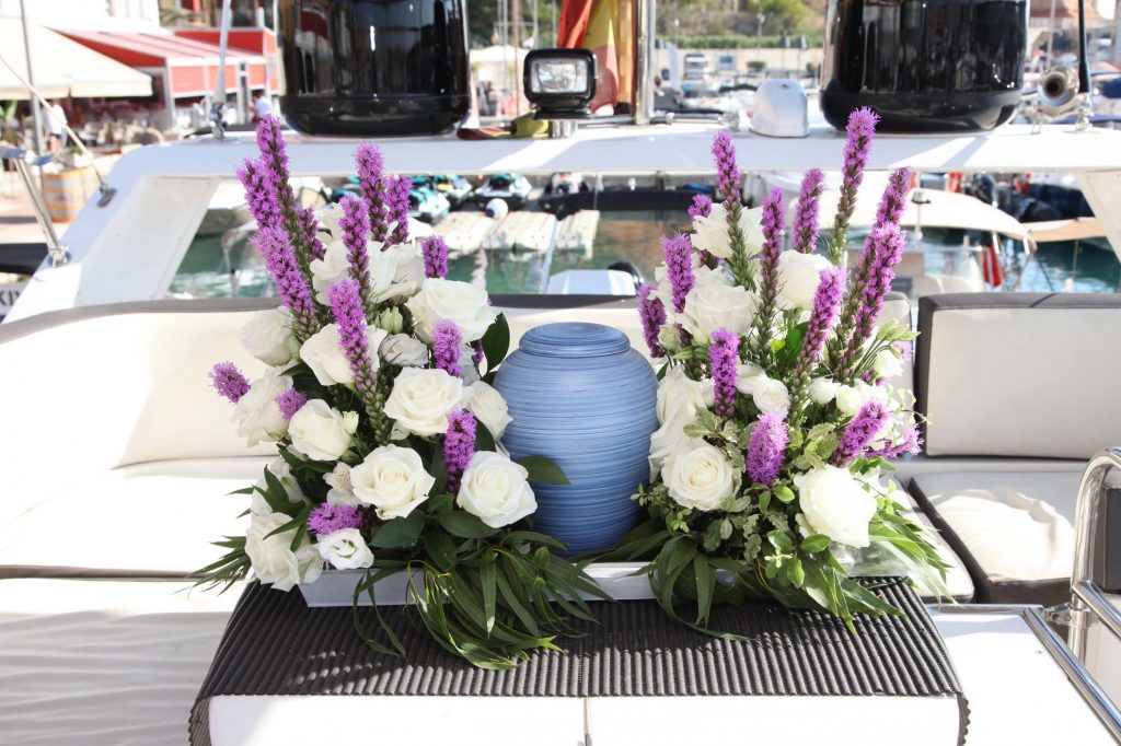 Flower arrangements onboard with the urn as the centerpiece